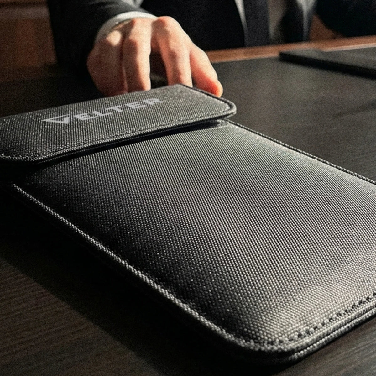 Faraday Sleeve Prime with the flap closed on a desk