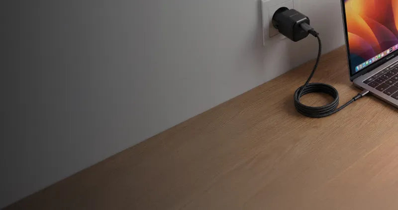 Velter power adapter and cable plugged in next to a laptop