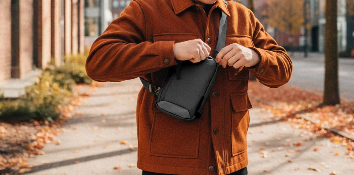 Man fastening a Velter sling bag worn across the chest